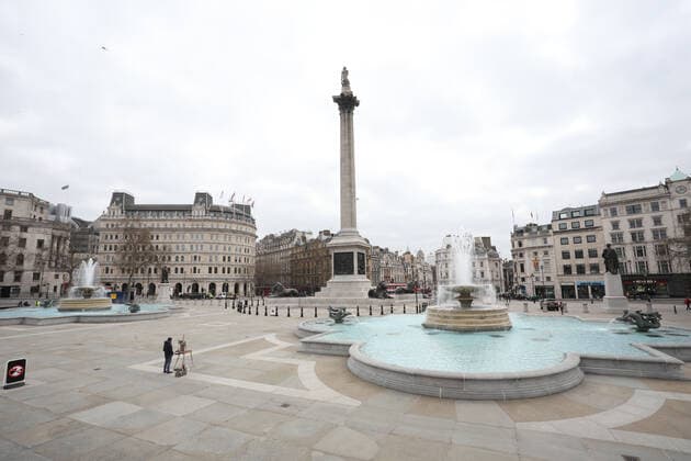 An artist stops working during the moment of reflection in Trafalgar Square. Today marks the first anniversary of the start of UK lockdown restrictions because of the COVID-19 Coronavirus pandemic. A national minute s silence at 12.00pm marks the moment of reflection. London is pictured today (March 23, 2021), on the anniversary of the first Coronavirus lockdown. 