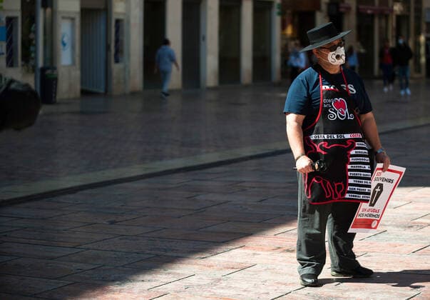 March 23, 2021, Malaga, Spain: A protester wearing a mask holds a placard at Plaza de la Constitucion square during the demonstration..Employees from S.O.S Souvenirs association in Malaga, who work in tourists stores of souvenirs, demand the Spanish government sector survival facing fall incomes due to coronavirus pandemic. Many tourist stores and shops have had to close after restrictions of tourist sector and arrivals of tourists in Spain. Malaga Spain - ZUMAs197 20210323_zaa_s197_012 Copyright: xJesusxMeridax