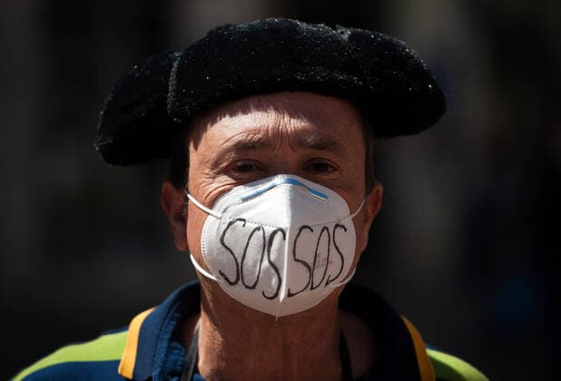 March 23, 2021, Malaga, Spain: A protester wearing a mask seen at Plaza de la Constitucion square during the demonstration..Employees from S.O.S Souvenirs association in Malaga, who work in tourists stores of souvenirs, demand the Spanish government sector survival facing fall incomes due to coronavirus pandemic. Many tourist stores and shops have had to close after restrictions of tourist sector and arrivals of tourists in Spain. Malaga Spain - ZUMAs197 20210323_zaa_s197_016 Copyright: xJesusxMeridax