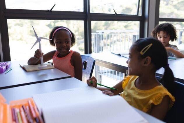 Happy schoolkids talking with each other at desk in classroom Side view of happy schoolkids talking with each other at desk in classroom of elementary school, model released, , property released, capetown, 28.01.2019, 1228092.jpg, school, classroom, desk, bench, casual clothing, school kid, schoolboy, schoolgirl, student, classmate, notebook, pencil, sitting, holding, smiling, looking, talking, drawing, coloring, class, art, skill, creativity, imagination, model, windmill, generator, childhood, innocence, development, education, academic, information, knowledge, lifestyle, elementary, intelligent, intelligence, wisdom, diverse, diversity, multi-ethnic, ethnicity, ethnically diverse, wind turbines, energy, inside, sustain Child, Boy, Male,