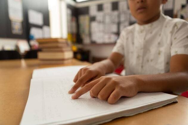 Blind schoolboy reading a braille book in classroom Mid section of blind focused mixed-race schoolboy reading a braille book in classroom at elementary school, model released, , property released, capetown, 26.02.2019, 1229721.jpg, school, classroom, bench, desk, casual clothing, school kid, schoolboy, student, standing, pointing, finger, reading, book, braille, code, disabled, handicapped, physical impairment, blind, study, studying, learning, attentive, focused, concentration, childhood, innocence, development, education, academic, information, knowledge, lifestyle, elementary, intelligent, intelligence, wisdom Child, Boy, Male, Mixed-Race, 6-7 Years, Boys, Mixed-Race Person Indoors,Front view,Close-up,Day,Mid Section