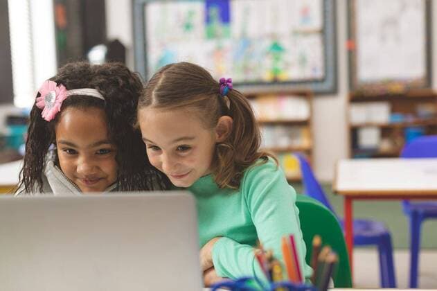 Two schoolgirl having a smirk while they working on their laptop Surface level view of two schoolgirl having a smirk while they working on their laptop in classroom at school, model released, , property released, Cork, Ireland, 05.02.2019, 1238437.jpg, school, classroom, desk, bench, casual clothing, school kid, schoolboy, schoolgirl, pen holder, laptop, notebook, scrunchie, smirk, smilling, computer, electronic, wireless technology, communication, connection, global communication, study, studying, learning, sitting, talking, speaking, childhood, innocence, development, education, academic, information, knowledge, lifestyle, elementary, intelligent, intelligence, wisdom, friend, friendship, diversity, caucasian ethnicity, mixed-race ethnic