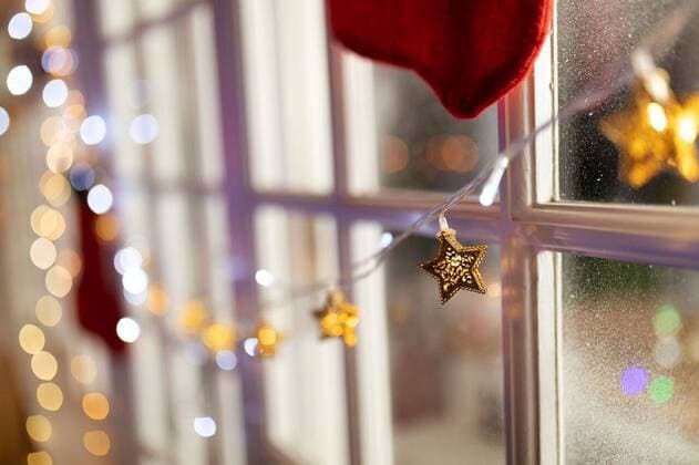 Family at home at Christmas time Close up of Christmas decoration of fairy lights in a window, model released, , property released, Cape Town, South Africa, 06.09.2019, 1289281.jpg, christmas, christmas time, xmas, yuletide, holidays, celebrating, celebration, festive, festivity, tradition, home, domestic life, family, merry, joyful, free time, enjoying, relaxing, sitting room, window, fairy lights, decoration, decorating Indoors,Copy space,Focus on Foreground,Day