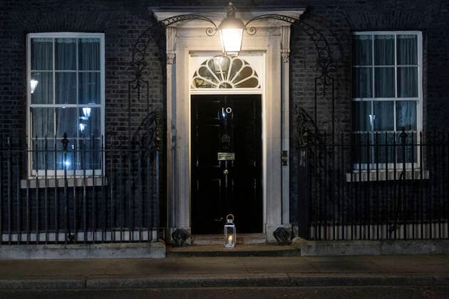(210324) -- LONDON, March 24, 2021 -- A lantern is seen on the doorstep of 10 Downing Street in London, Britain, on March 23, 2021. Britain on Tuesday marked one year since British Prime Minister Boris Johnson announced the first coronavirus lockdown in the country last year. On March 23, 2020, Johnson unveiled measures to stop the spread of COVID-19. A national minute s silence was held at midday as part of a day of reflection. Britons are also encouraged to stand on their doorsteps at 2000 GMT with phones, candles and torches to remember the past year. (Photo by Xinhua) BRITAIN-LONDON-COVID-19-NATIONAL DAY OF REFLECTION RayxTang 