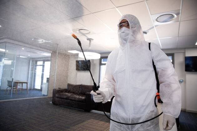 Health worker wearing protective clothes cleaning the office using disinfectant Worker wearing protective suit, face mask and gloves sanitizing office using an anti bacterial disinfectant spray. Hygiene in workplace during Coronavirus Covid 19 pandemic., model released, , property released, Cape Town, South Africa, 12.09.2020, 1373328.jpg, work,working,healthcare,safety,protection,worker,spray,spraying,serious,real people,hygiene,face mask,protective suit,safety glasses,gloves,cleaner,cleaning,cleansing,disinfecting,disinfectant,sanitizing,anti-bacteria,virus,office,workplace,coronavirus,covid19,pandemic,epidemic,health,health scare,global,outbreak,contagious,contagion,care,disease,health hazard,infection,agency,company,modern
