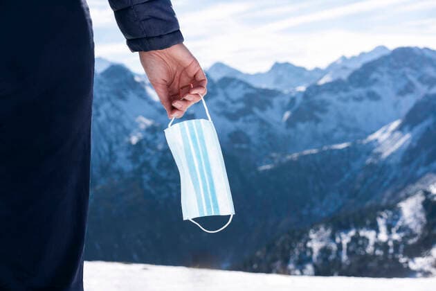 Woman s hand holding surgical mask during winter model released Symbolfoto AKLF00057