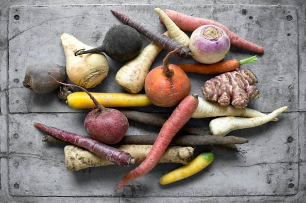 Raw vegetables lying on gray wooden surface ASF06721