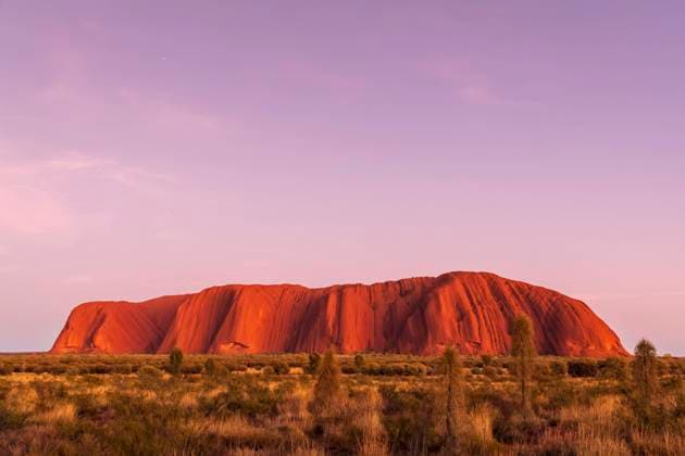 Australia, Northern Territory, Purple sky over Ayers Rock at dusk property released FOF12053
