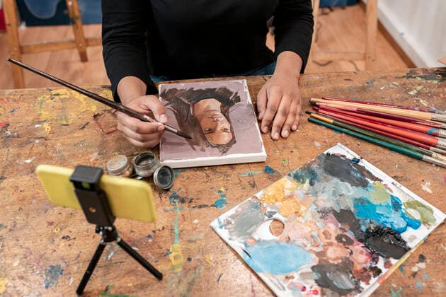 Young female artist painting on canvas at art studio model released Symbolfoto property released JCCMF01312