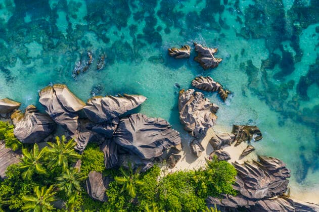 Creative Highlights World Drone view of granite rock formations of Anse Source DArgent beach in summer RUEF03204
