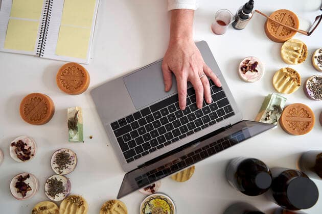 Female entrepreneur s hand typing on laptop over table model released Symbolfoto property released VEGF03990