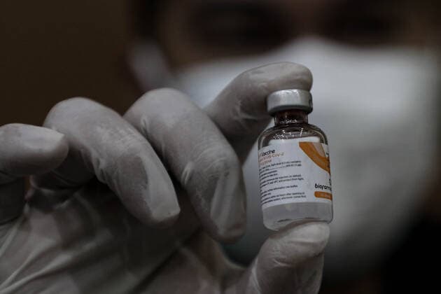 March 25, 2021, Depok, Jawa Barat, Indonesia: A healthcare worker holds a vial with a dose of Sinovac COVID-19 vaccine during a mass vaccination drive for the public sector workers at Geospatial Information Agency Office in Bogor..Indonesia is currently in the second phase of mass covid-19 vaccination. In this second phase, the Indonesian government targets 38.5 million people, including 16.9 million workers in public sectors and 21.6 million elderly citizens, as well as workers in hospitality, transportation, tourism sectors and mass media workers. Depok Indonesia - ZUMAs197 20210325_zaa_s197_086 Copyright: xRisaxKrisadhix