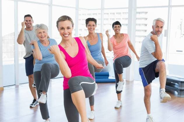 Smiling people doing power fitness exercise at yoga class Portrait of smiling people doing power fitness exercise at yoga class in fitness studio, model released, Cape Town, South Africa, 22.11.2013, 309845.jpg, fitness, exercise, balance, leisure, stretching, gym, yoga, pilates, active, activity, body, club, fit, flexibility, flexible, healthy, lifestyle, physical, shape, sportswear, sporty, stretch, training, wellness, workout, health, fitness studio, working out, class, sport, group, toned, athletic, slim, slender, attractive, pretty, beautiful, body care, bending, standing, exercising, exercise room, instructor, trainer, smiling, happy, dancing, aerobics, portrait 20s, Young Adult, Man, Male, Caucasian, 50s, Mature Adult, 60s, Senior,