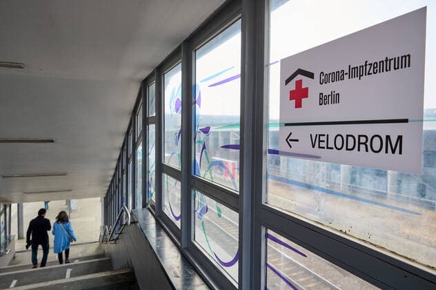 Wegweiser zum Corona-Impfzentrum im Berliner Velodrom am S-Bahnhof Landsberger Allee in Berlin. Signpost to the Corona vaccination centre in the Berlin Velodrom at Landsberger Allee S-Bahn station in Berlin. snapshot-photography F.Boillot