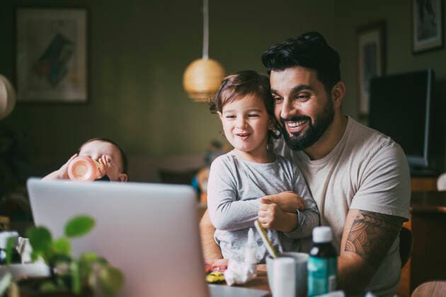 Smiling son and father taking online advice through laptop at home during pandemic Sweden, Stockholm, model released, property released Copyright: xMaskotx , MA85653
