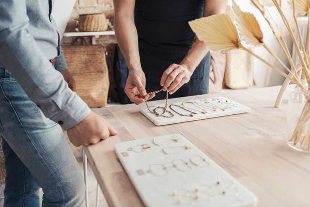 Midsection of male entrepreneurs with bracelets standing by customer in design studio Sweden, Malmo, model released, property released Copyright: xKentarooxTrymanx , MA85218