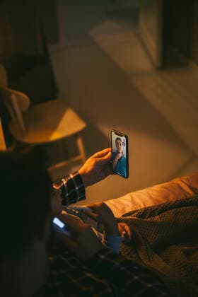 High angle view of sick man online consulting through video call on smart phone at home Sweden, Stockholm, model released, property released Copyright: xMaskotx , MA85610