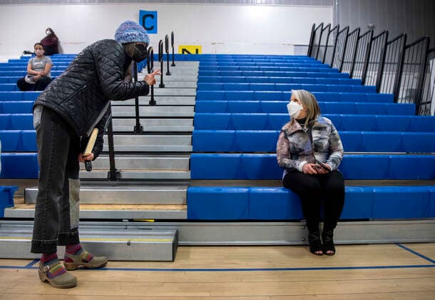 March 26, 2021, USA: Kimber Seymour, left, a school nurse for Santa Fe Public Schools, thanks New Mexico Governor Michelle Lujan Grisham for the way she has handled the COVID-19 pandemic in New Mexico. They were waiting after receiving their Pfizer COVID-19 vaccine during a vaccination event held in the gym at Desert Sage Academy in Santa Fe, Friday March 26, 2021. USA - ZUMAab1_ 20210326_zaf_ab1_006 Copyright: xEddiexMoorex