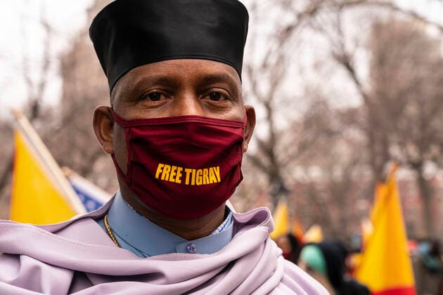 Members of Tigray diaspora of the US rally and march Protesters with Tigray flags and posters staged rally on Washington Square and walk along Broadway demanding end of Ethiopia offence on civilians. Conflict between Tigray Regional Government and Ethiopian Government started in 2019 and escalated into an open war on November 4, 2020. More than 2.3 million children are cut off from desperately needed aid and humanitarian assistance. Many protesters were wearing jackets, hat and facial masks in colors of Tigray flag. Aba (father) Gebre Hiwot from Washington DC church Medhane Alem seen on this photo. New York New York United States Copyright: LevxRadin