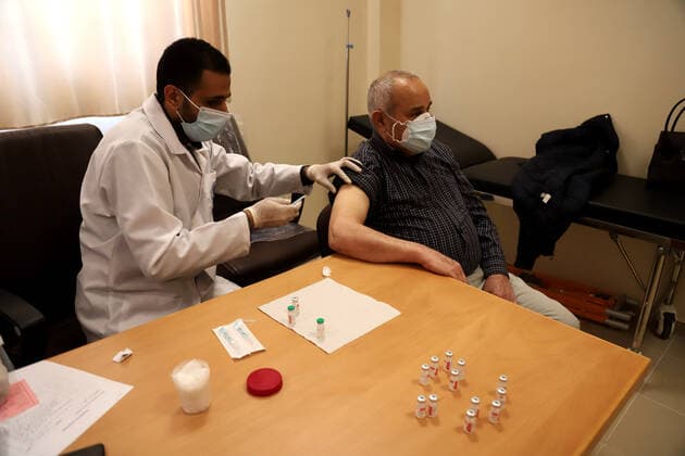 March 27, 2021, Gaza city, Gaza Strip, Palestinian Territory: Palestinians receive the dose of the coronavirus disease (COVID-19) vaccine at the UNRWA clininc, in Gaza city on March 27, 2021. The Palestinian authorities have begun administering vaccines supplied under the international Covax vaccine-sharing scheme, as infections continue to rise sharply in the West Bank and Gaza Gaza city Palestinian Territory - ZUMAap3_ 20210327_zaf_ap3_004 Copyright: xMahmoudxAjjourx