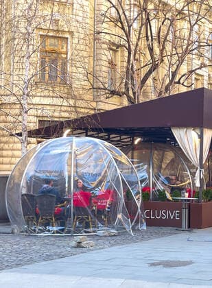 Old town with restaurants and bars with tourists and local people in Bucharest, Romania on March 27, 2021.