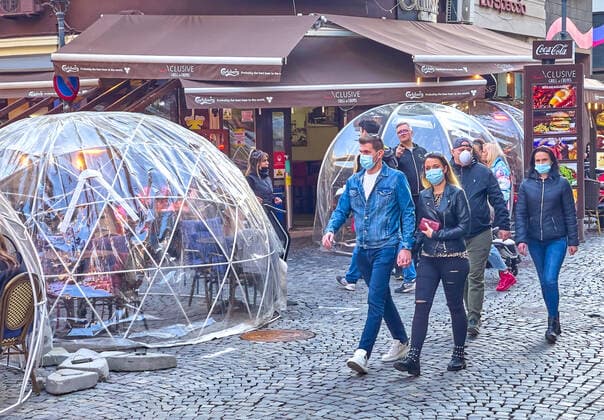 Corona bubbles, protective covers made of plastic in the Old town with restaurants and bars with tourists and local people in Bucharest, Romania on March 27, 2021.