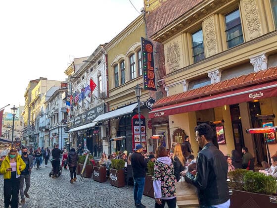 Old town with restaurants and bars with tourists and local people in Bucharest, Romania on March 27, 2021.