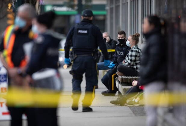 March 27, 2021, North Vancouver, BC, Canada: An RCMP officer speaks with a woman outside the Lynn Valley Library, in North Vancouver, B.C., Saturday, March 27, 2021. Police say multiple victims were stabbed inside and outside the library today. North Vancouver Canada  - ZUMAc35_ 20210327_zaf_c35_030 Copyright: xDarrylxDyckx