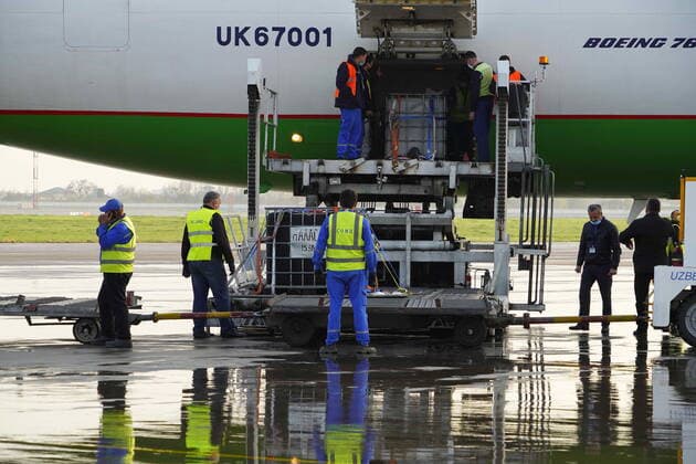 (210327) -- TASHKENT, March 27, 2021 -- Workers unload COVID-19 vaccines at Tashkent International Airport in Tashkent, Uzbekistan, on March 27, 2021. The first batch of Chinese coronavirus vaccines arrived in Uzbekistan Saturday. (Photo by Xinhua) UZBEKISTAN-TASHKENT-CHINA-COVID-19 VACCINES-ARRIVAL ZafarxKhalilov 