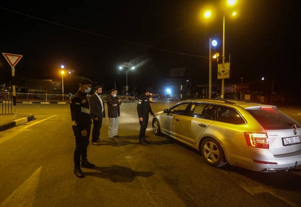 (210328) -- GAZA, March 28, 2021 -- Palestinian police officers work at a checkpoint in the Gaza Strip city of Khan Younis, March 27, 2021. The Hamas-run Interior Ministry imposed a full lockdown on Saturday all over the Gaza Strip at night-time from 9:00 PM due to increasing numbers of COVID-19 infection. (Photo by Xinhua) MIDEAST-GAZA-KHAN YOUNIS-COVID-19 YasserxQudih 