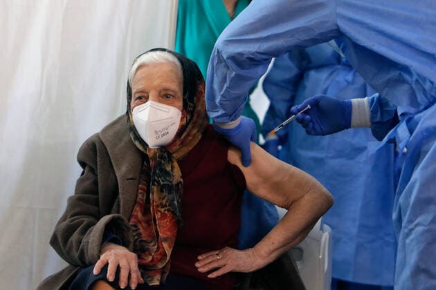 (210328) -- BUCHAREST, March 28, 2021 -- Zoea Baltag, 105-year-old, receives the second shot of COVID-19 vaccine at a hospital in Bucharest, Romania, March 28, 2021. (Photo by Xinhua) ROMANIA-BUCHAREST-COVID-19-VACCINATION CristianxCristel 
