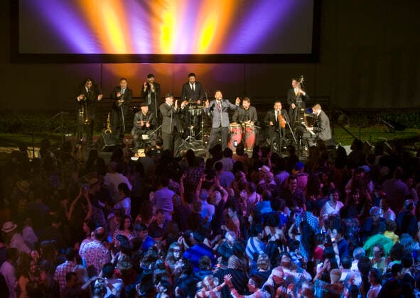 March 28, 2021, Costa Mesa, California, USA: Boogaloo Assassins perform in the plaza at the Segerstrom Center for the Arts. The Boogaloo Assassins is a12 piece Boogaloo, Salsa and Latin Soul group from Los Angeles, California. Costa Mesa USA - ZUMAk145 20210328_zap_k145_111 Copyright: xNicholasxKoonx