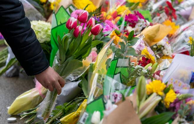 March 28, 2021, North Vancouver, BC, Canada: A person lays flowers at a makeshift memorial outside of the Lynn Valley Library in Lynn Valley in North Vancouver, B.C., Sunday, March 28, 2021. A 28-year-old man was charged Sunday with second-degree murder in a stabbing rampage that left a young woman dead and injured six others in and around a library in North Vancouver, B.C., a day earlier. North Vancouver Canada - ZUMAc35_ 20210328_zaf_c35_103 Copyright: xJonathanxHaywardx