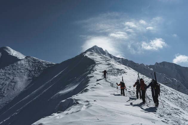 Rear view of people with backpacks and splitboards climbing snowcapped mountain against sky Rishiri, Hokkaido, Japan CR_BRHU210328-687565-01 ,model released, Symbolfoto