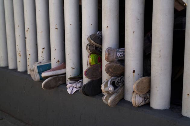 March 28, 2021, Tijuana, Mexico: Various migrantÃ¢â‚¬â ¢s shoes are seen at the border wall in Tijuana, Mexico. Migrants from Central America are stuck living in tents on the street in Tijuana, Mexico on the border while they wait for President Joe Biden to open the American border. Tijuana Mexico - ZUMAd211 20210328_zap_d211_021 Copyright: xAllisonxDinnerx