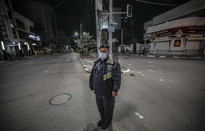 March 28, 2021, Gaza city, The Gaza Strip, Palestine: Palestinian policemen stand guard in the streets amid a coronavirus lockdown from 9:00 PM to 6:00 AM in Gaza City, 27 March 2021. The Ministry of Interior in Gaza City announced new measures on .25 March 2021, as number of coronavirus positive cases increase. Gaza city Palestine - ZUMAq100 20210328_zaa_q100_053 Copyright: xAbedxAlrahmanxAlkahloutx