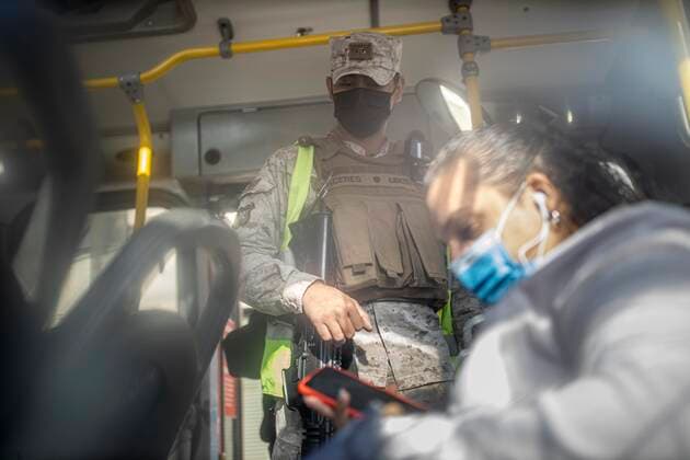 March 29, 2021, Santiago, Chile: A military man verifies the health permits of the passengers on a public transport bus..Sanitary cords and police controls during the first day of total quarantine in the central area of the country, after the abrupt increase in Covid-19 cases in the Metropolitan region, the country s health authorities decreed a total quarantine for the central area of the country. Although Chile leads the number of vaccinated population, the increase in positive cases puts the stability of the health system at risk again. Santiago Chile - ZUMAs197 20210329_zaa_s197_159 Copyright: xFelipexFigueroax
