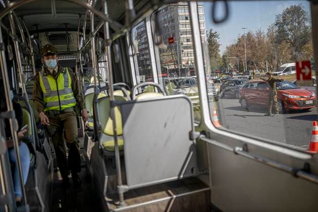 March 29, 2021, Santiago, Chile: A police officer verifies the health permits of the passengers on a public transport bus..Sanitary cords and police controls during the first day of total quarantine in the central area of the country, after the abrupt increase in Covid-19 cases in the Metropolitan region, the country s health authorities decreed a total quarantine for the central area of the country. Although Chile leads the number of vaccinated population, the increase in positive cases puts the stability of the health system at risk again. Santiago Chile - ZUMAs197 20210329_zaa_s197_166 Copyright: xFelipexFigueroax