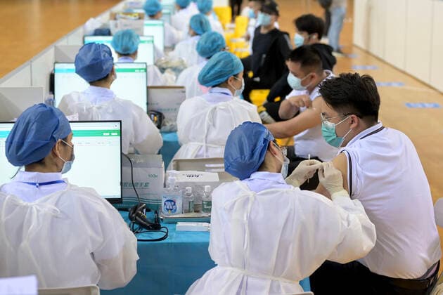 NANNING, CHINA - MARCH 29: Local residents line up to receive the COVID-19 vaccine at Guangxi Sports Center gymnasium on March 29, 2021 in Nanning, Guangxi Zhuang Autonomous Region of China.  Copyright: xVCGx CFP111323471518