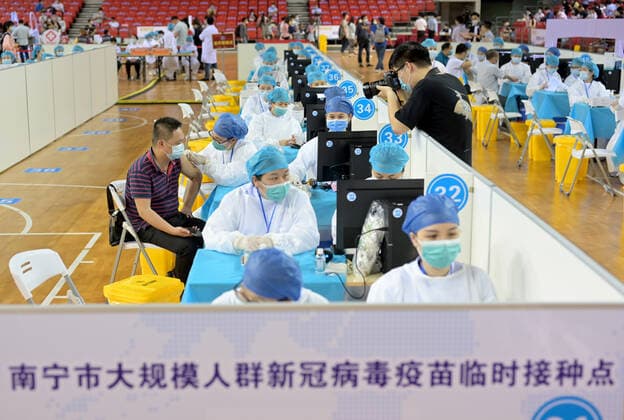 NANNING, CHINA - MARCH 29: Local residents line up to receive the COVID-19 vaccine at Guangxi Sports Center gymnasium on March 29, 2021 in Nanning, Guangxi Zhuang Autonomous Region of China.  Copyright: xVCGx CFP111323471520