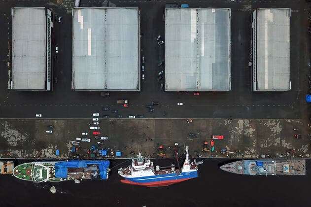 OTRADNOYE, LENINGRAD REGION, RUSSIA - MARCH 30, 2021: The heeled over Skorpion trawler (C bottom) is pictured at the Pella Shipyard. The vessel that is under construction, heeled over and the holds were flooded on March 30. Six workers were able to evacuate; a rescue operation for two people is underway. Peter Kovalev TASS  TS0FB01A