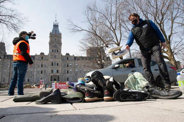 March 30, 2021, QUEBEC, PQ, Canada: SCFP union workers pile up shoes in front of the National Assembly as demonstrators drive around in their cars, Tuesday, March 30, 2021 in Quebec City. Union workers claim negotiations are at a standstill and give it as the reason to drop shoes. QUEBEC Canada  - ZUMAc35_ 20210330_zaf_c35_029 Copyright: xJacquesxBoissinotx