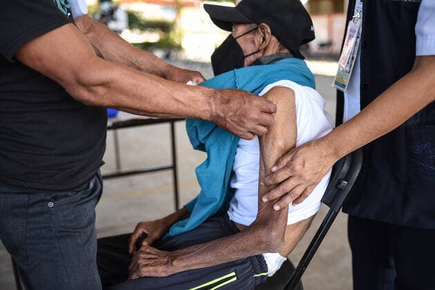 March 30, 2021, Tuzamapan, Veracruz, Mo xico: The musical group Los super Caracoles plays their songs while older adults wait in line to be vaccinated against Covid-19. Some older adults joined the dance and celebration to receive the vaccine Tuzamapan MÃ xico - ZUMAqp1_ 20210330_zip_qp1_003 Copyright: xHectorxAdolfoxQuintanarxPerezx