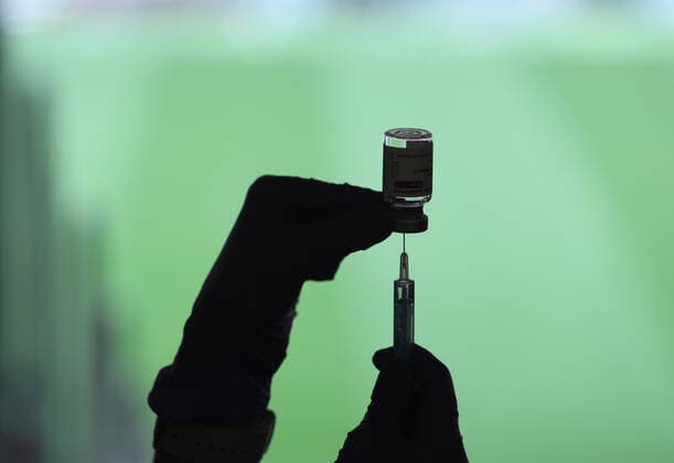 A health professional holds a syringe and a vial with the Covid-19 vaccine, in a device installed at the Wanda Metropolitano Stadium, in Madrid, Spain, on March 30, 2021. The Community of Madrid has begun to vaccinate this Tuesday against Covid-19 to the general population aged 60 to 65 years with doses of AstraZeneca. Also, next week will begin to vaccinate people aged 77, 78 and 79 years with doses of Pfizer. 30 MARCH 2021;WANDA METROPOLITANO;MADRID;COMMUNITY OF MADRID Marta Fernandez Jara LagenciaEP 03 30 2021 MADRID MADRID Spain Copyright: xMartaxFernandezxJarax 3627703