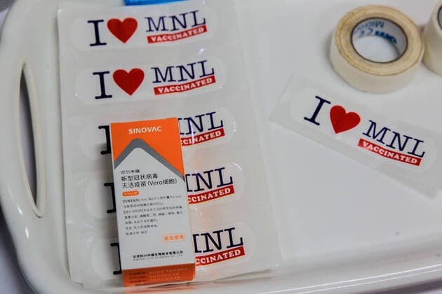(210331) -- MANILA, March 31, 2021 -- A box of Sinovac vaccine is seen on stickers to be used as signs after vaccination at a vaccination site in Manila, the Philippines on March 31, 2021. The Philippines Department of Health (DOH) reported on Wednesday 6,128 new COVID-19 infections, bringing the total number of confirmed cases in the Southeast Asian country to 747,288. ) PHILIPPINES-MANILA-COVID-19-SINOVAC VACCINES RouellexUmali 
