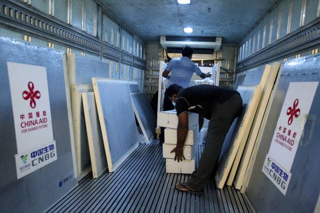 (210401) -- COLOMBO, April 1, 2021 -- Workers unload Sinopharm COVID-19 vaccines at the Bandaranaike International Airport in Colombo, Sri Lanka, March 31, 2021. A batch of Sinopharm vaccines arrived in Sri Lanka from China on Wednesday as part of a donation by the Chinese government to the island nation. (Photo by Xinhua) SRI LANKA-COLOMBO-CHINA-COVID-19-VACCINES-ARRIVAL AjithxPerera 