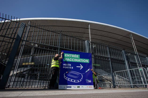 Coronavirus in Frankreich, neues Impfzentrum im Stade de France in Paris (210331) -- SAINT-DENIS (FRANCE), March 31, 2021 -- Staff members set up a sign of a new COVID-19 vaccination center in Saint-Denis, France, on March 31, 2021. Starting from mid-April people over 60 in France will be able to get vaccinated, from May 15 the vaccination will be open to people aged between 50 and 60 and from mid-June the age limit will be lifted, said French President Emmanuel Macron on Wednesday. (Photo by Xinhua) FRANCE-SAINT-DENIS-VACCINATION CENTER AurelienxMorissard 