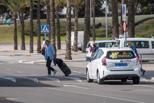 20210401 Tourists arrive at Palma de Mallorca Airport PALMA, SPAIN - APRIL 1 2021 : Tourists at Palma de Mallorca Ariport at - Tourists arrive at Palma de Mallorca Airport on April 1, 2021 in Palma, .