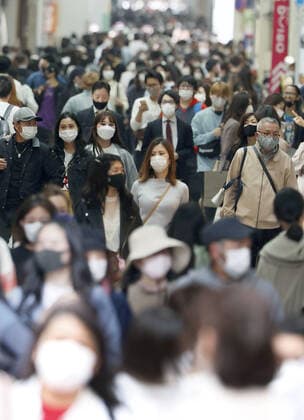 Scene of Osaka amid coronavirus pandemic People wearing face masks walk in Osaka s Minami area on April 2, 2021, amid a resurgence in coronavirus infections in the western Japan prefecture. 