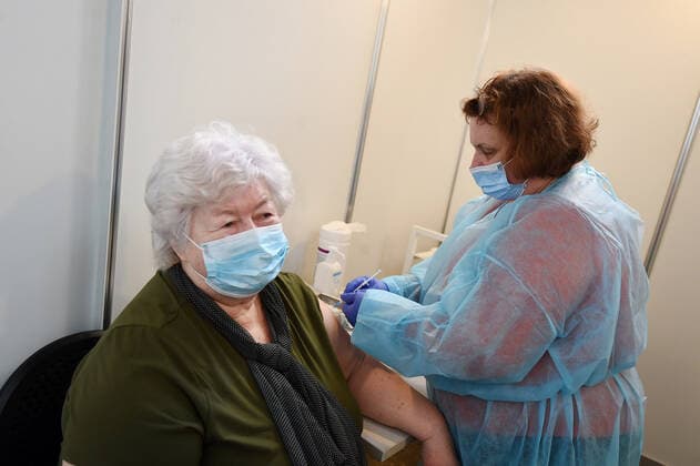 (210403) -- RIGA, April 3, 2021 -- A woman receives a dose of the COVID-19 vaccine at a mass immunization center in Riga, Latvia, on April 3, 2021. Latvia on Saturday opened mass immunization centers in eight cities and towns in a bid to ramp up vaccinations against COVID-19, health authorities informed. (Photo by Xinhua) LATVIA-RIGA-COVID-19-MASS IMMUNIZATION CENTER-OPENING EdijsxPalens 
